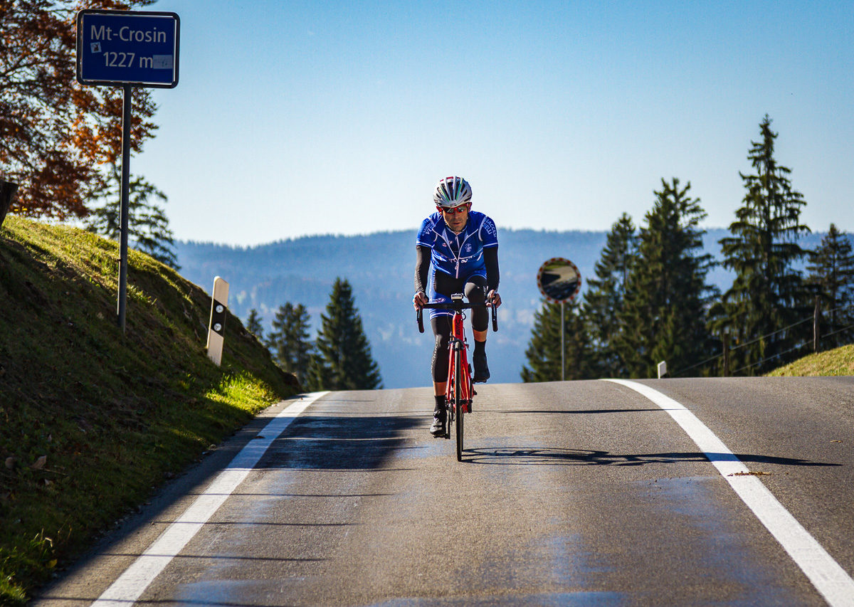 One male cyclist at the top of Mont Crosin in Canton Bern, Switzerland