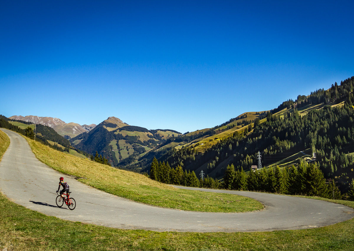 Lone cyclist climbing Mittelbergpass in Switzerland