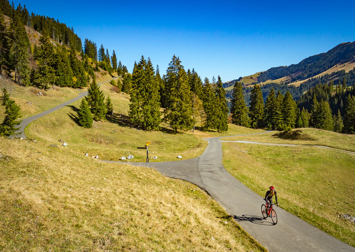 Lone cyclist climbing Mittelbergpass in Switzerland
