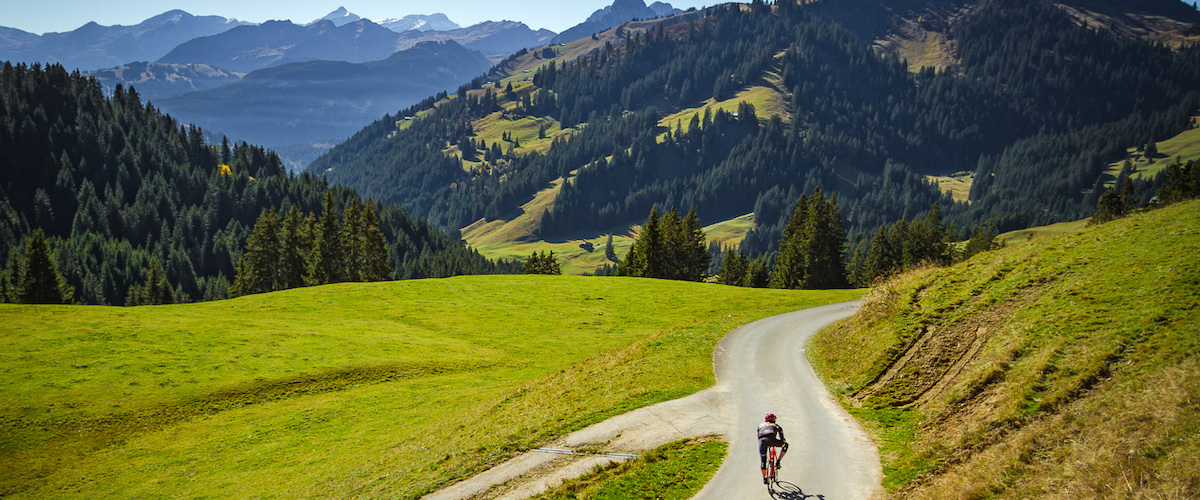 Lone cyclist descending Mittelbergpass in Switzterland