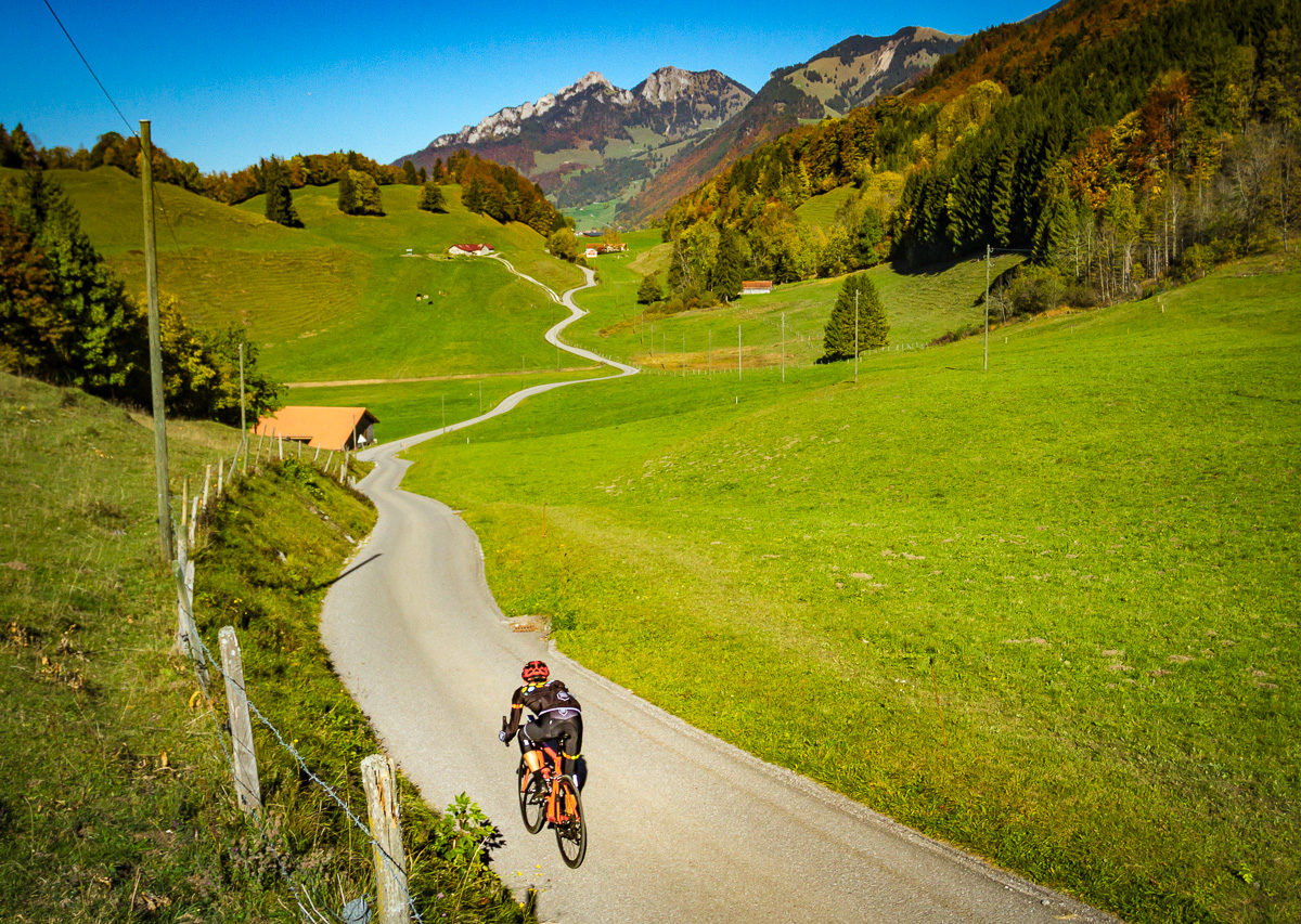 Lone cyclist riding in the Gruyère region in Switzerland