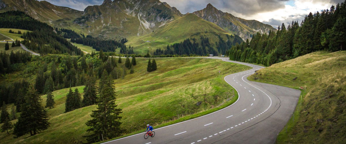 One male cyclist climbing Gurnigelpass in Kanton Bern, Switzerland