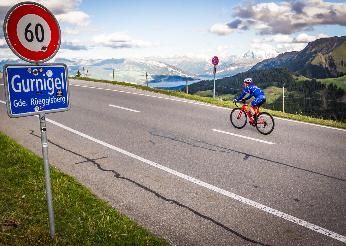 One male cyclist at the top of Gurnigelpass in Kanton Bern, Switzerland