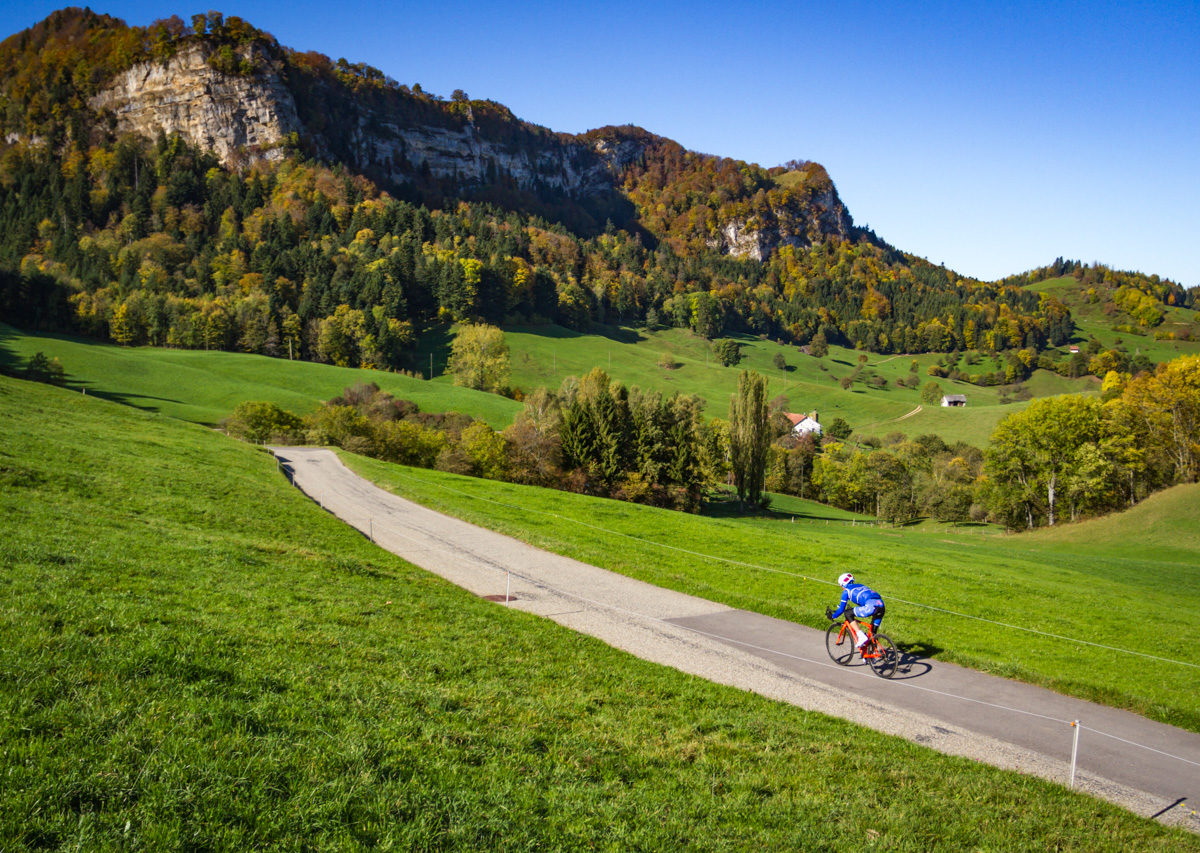 One male cyclist riding down Belchenpass in Kanton Baselland, Switzerland