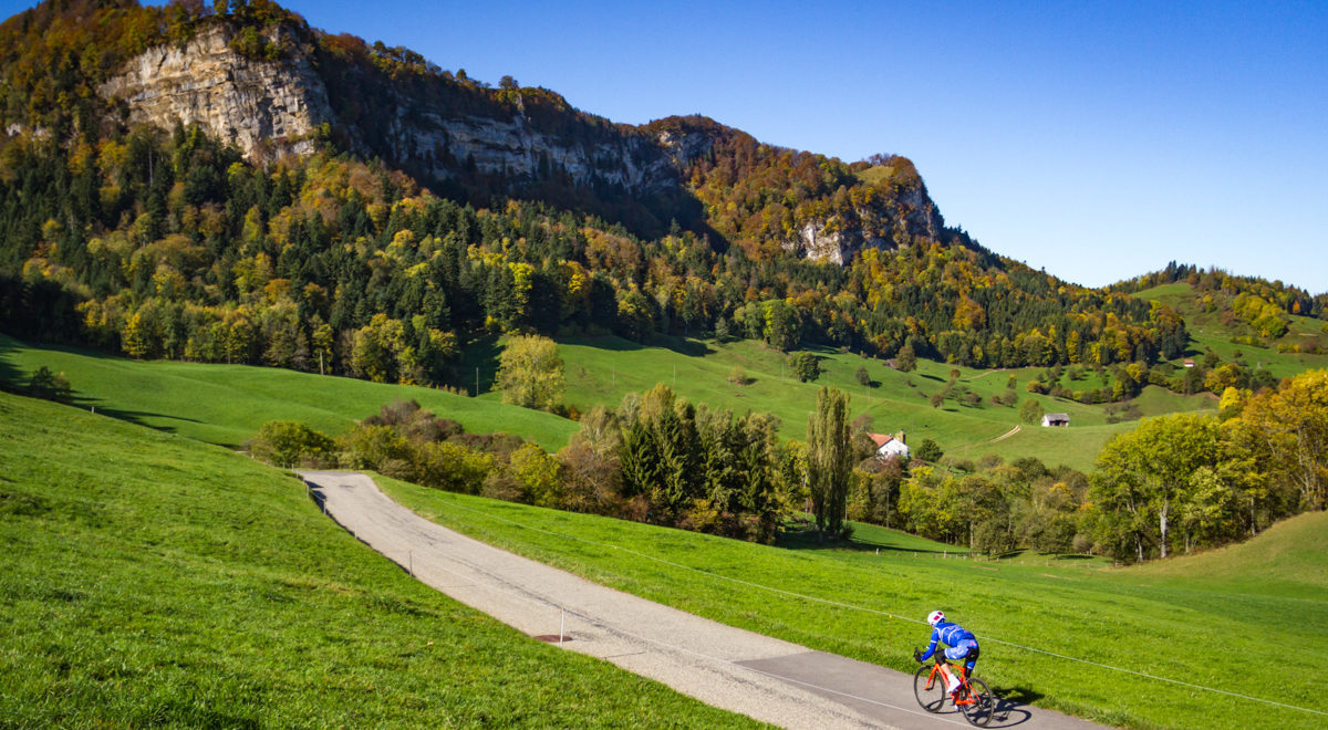 One male cyclist riding down Belchenpass in Kanton Baselland, Switzerland