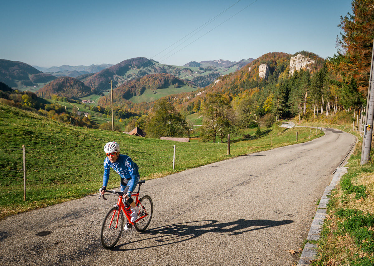 One male cyclist climbing Belchenpass in Kanton Baselland, Switzerland One male cyclist climbing Belchenpass in Kanton Baselland, Switzerland