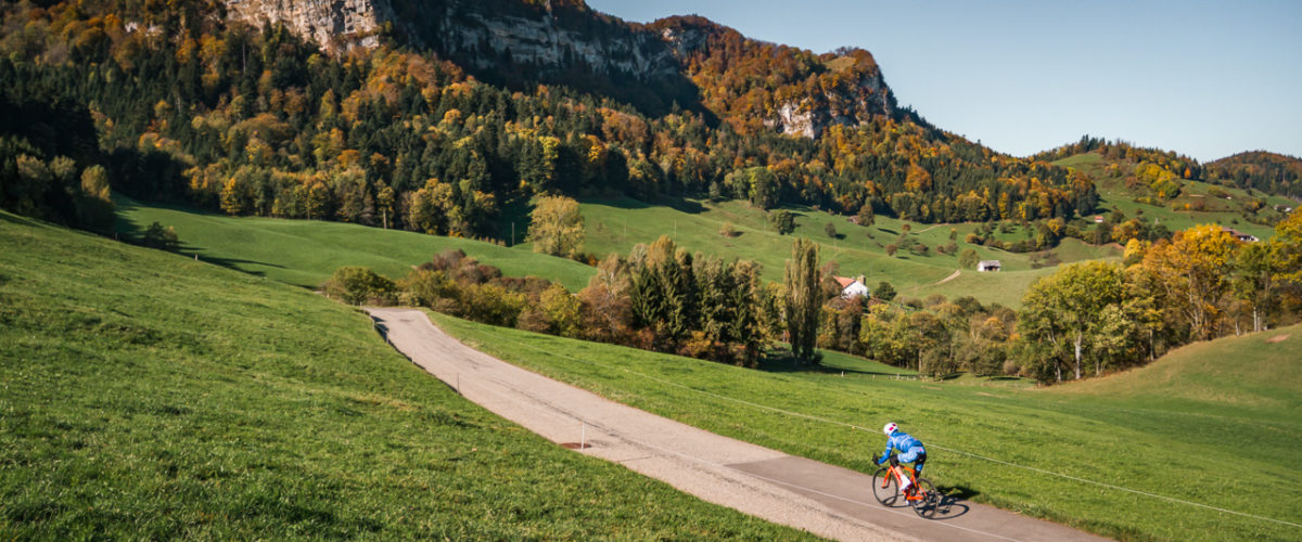 One male cyclist riding down Belchenpass in Kanton Baselland, Switzerland One male cyclist riding down Belchenpass in Kanton Baselland, Switzerland