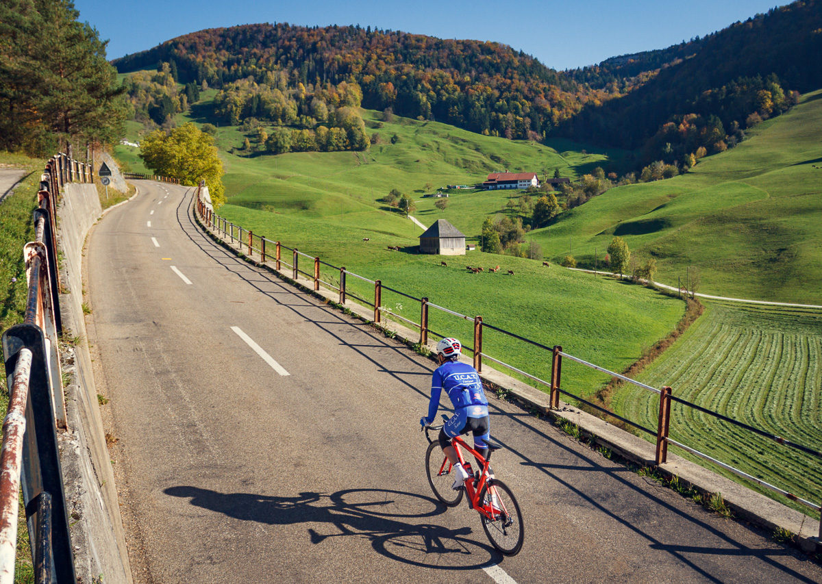 One male cyclist climbing Passwang in Kanton Solthurn, Switzerland One male cyclist climbing Passwang in Kanton Solthurn, Switzerland