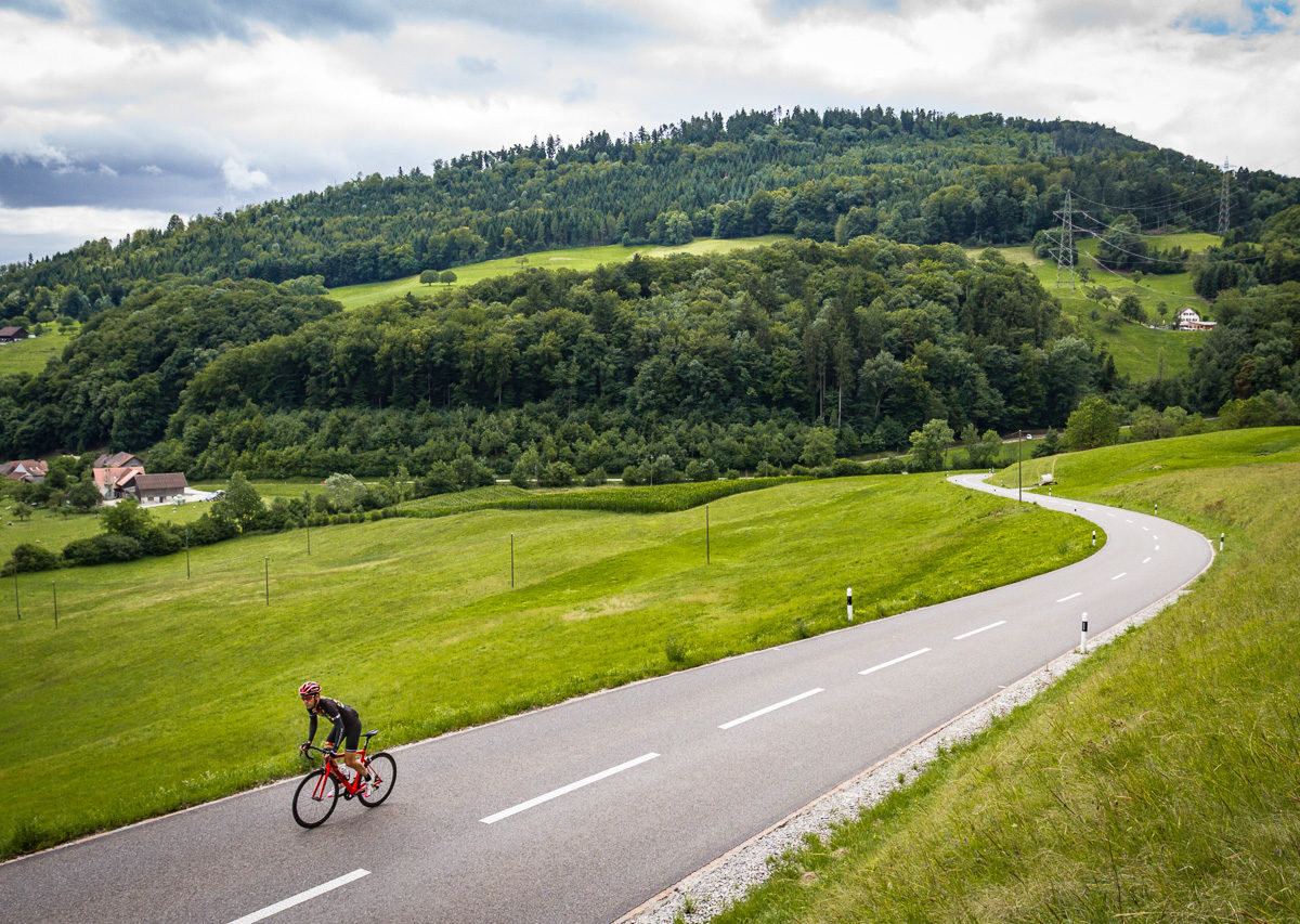 One male cyclist climbing Saalhöhe in Kanton Aargau, Switzerland One male cyclist climbing Saalhöhe in Kanton Aargau, Switzerland