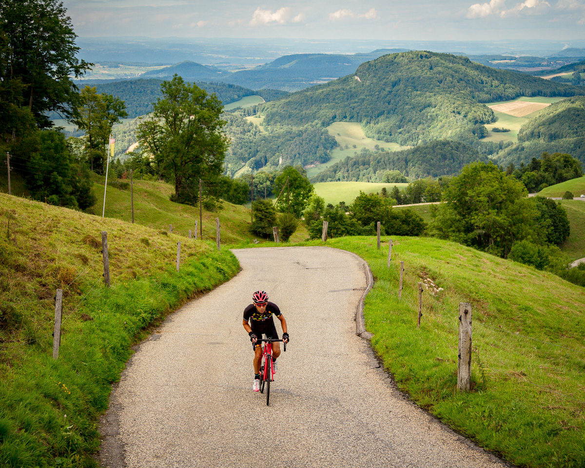 Switzerland Tourism-7600 One male cyclist climbing Belchenpass (Jura mountains) in Kanton Baselland, Switzerland