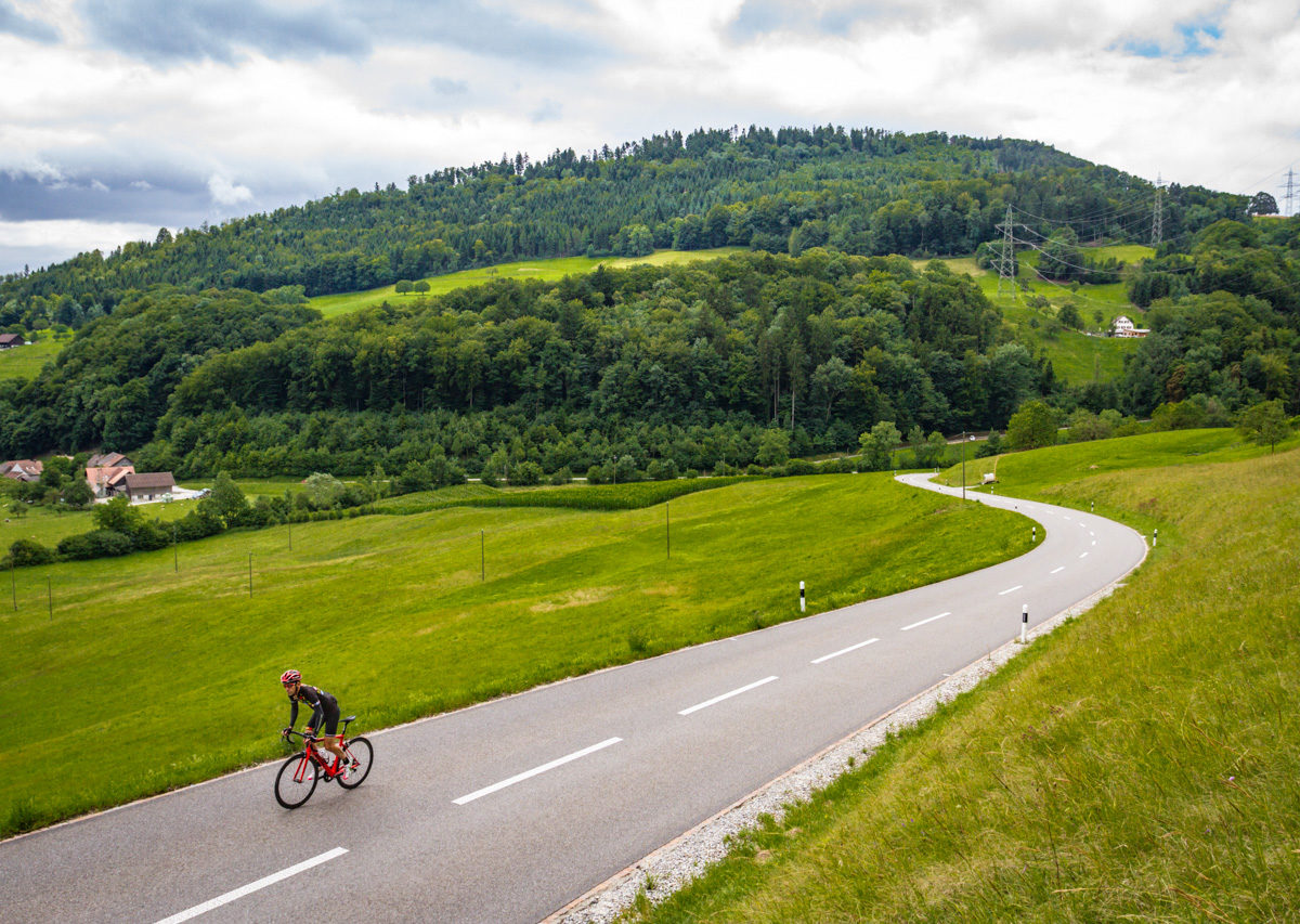 One male cyclist climbing Saalhöhe in Kanton Aargau, Switzerland One male cyclist climbing Saalhöhe in Kanton Aargau, Switzerland