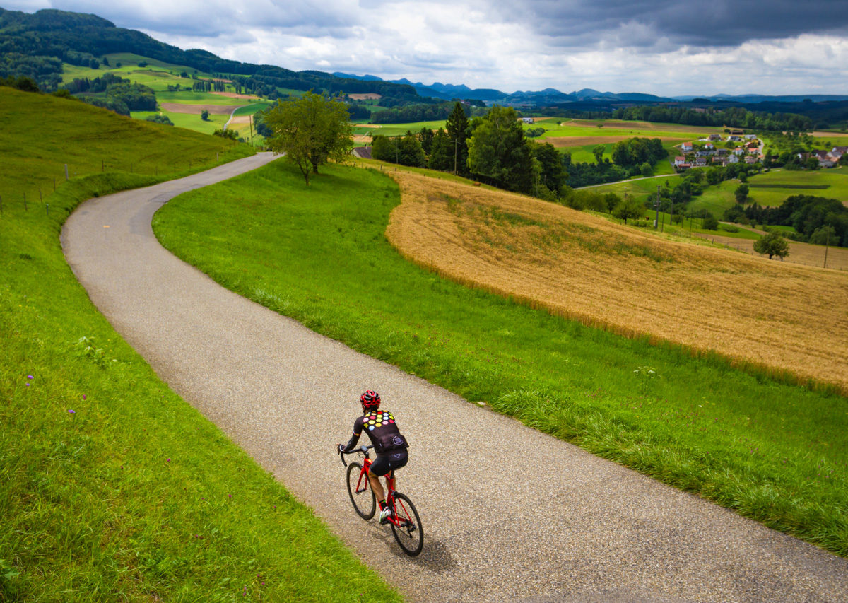 The Mittelland-7354 One male cycling riding in the Baselbiet region in Kanton Baselland, Switzerland