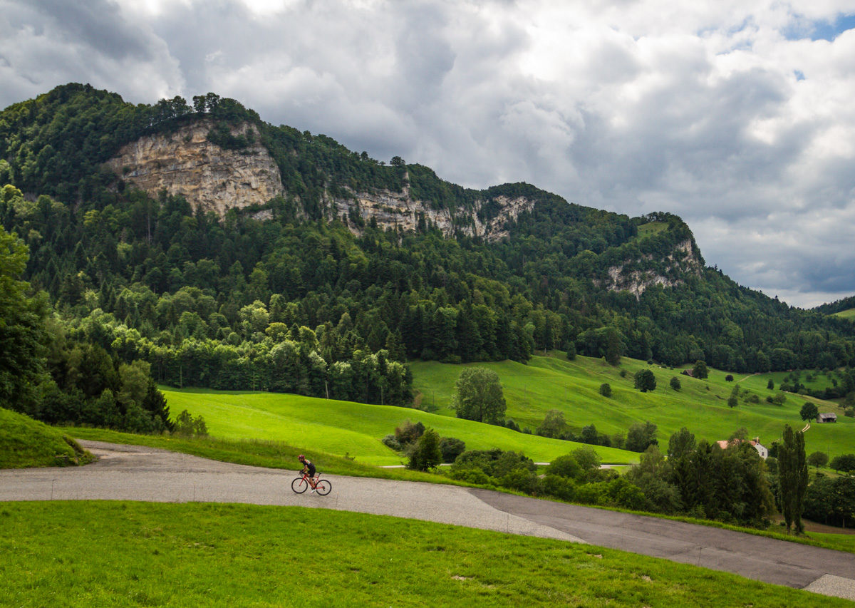 The Mittelland-7456 One male cyclist climbing Belchenpass (Jura mountains) in Kanton Baselland, Switzerland