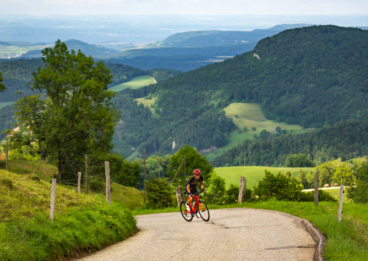 The Mittelland-7541 One male cyclist climbing Belchenpass (Jura mountains) in Kanton Baselland, Switzerland