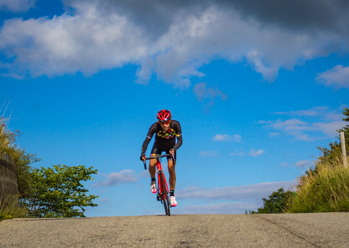 The Mittelland-7656 One male cyclist at the top of Belchenpass (Jura mountains) in Kanton Baselland, Switzerland